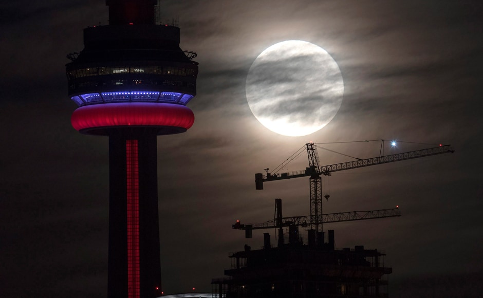 The supermoon sets behind the CN tower in Toronto on Monday. The Canadian Press via AP The supermoon sets behind the CN tower in Toronto on Monday. The Canadian Press via AP