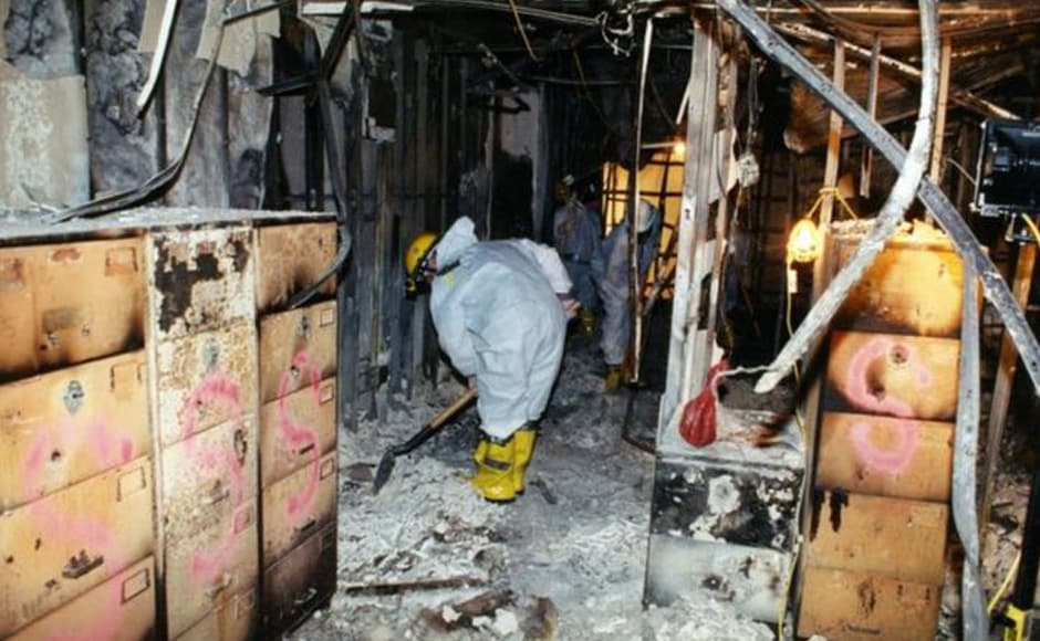 Investigators shovel ash from inside the building. In the newly released photos, the immediate devastation of the attack and the fire engulfing the building can be seen. Photo courtesy: FBI Investigators shovel ash from inside the building. In the newly released photos, the immediate devastation of the attack and the fire engulfing the building can be seen. Photo courtesy: FBI