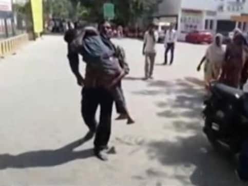 In UP's Etawah, labourer carries body of 15-year-old son after hospital 'denies help' In UP's Etawah, labourer carries body of 15-year-old son after hospital 'denies help'