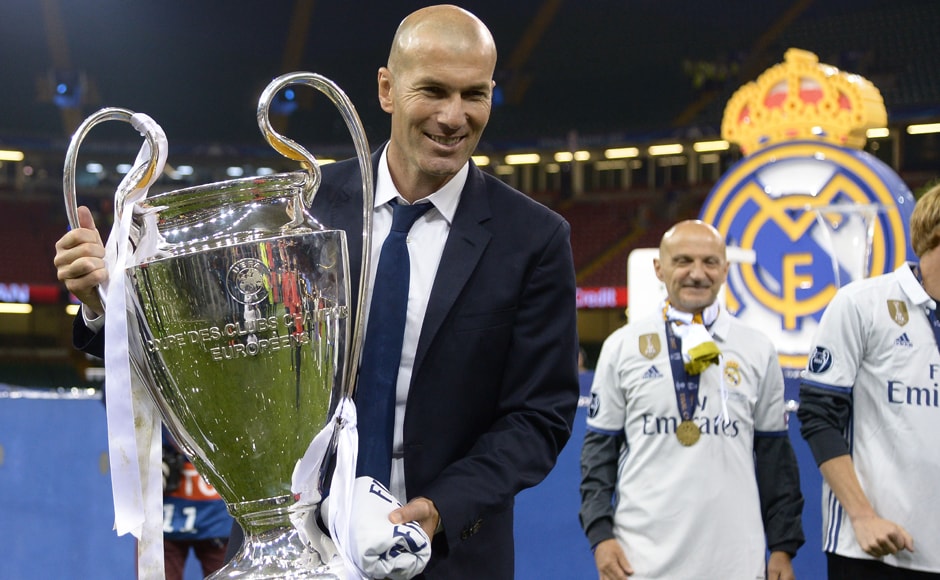 Real Madrid's French coach Zinedine Zidane lifts the trophy after Real Madrid won the UEFA Champions League. AFP Real Madrid's French coach Zinedine Zidane lifts the trophy after Real Madrid won the UEFA Champions League. AFP