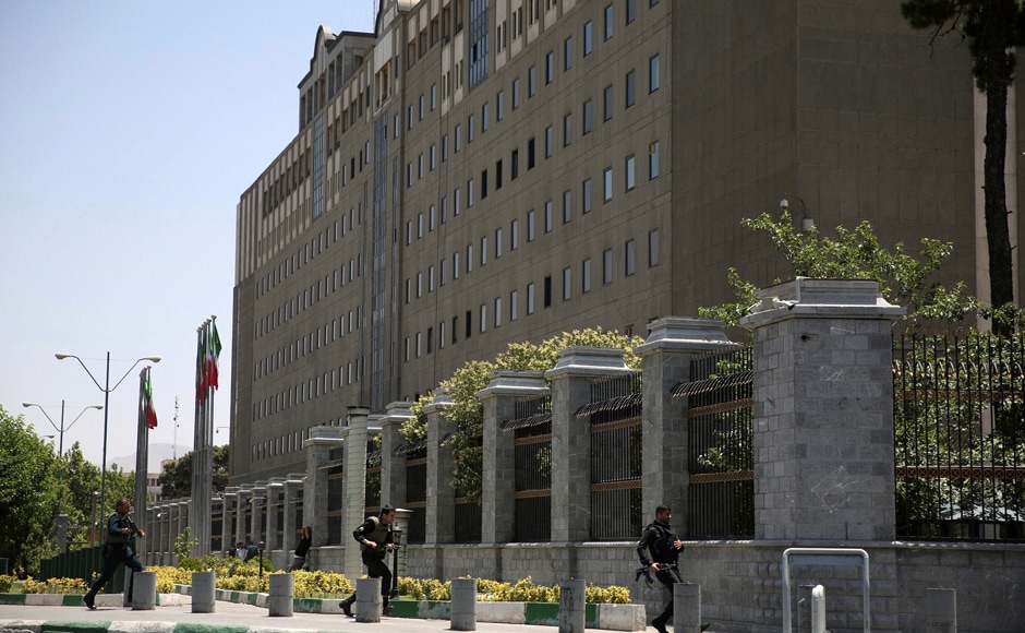 Police officers take position around Iran's Parliament building after an assault by several attackers in Tehran on Wednesday. The attackers killed a security guard and wounded 12 other people in twin attacks. AP Police officers take position around Iran's Parliament building after an assault by several attackers in Tehran on Wednesday. The attackers killed a security guard and wounded 12 other people in twin attacks. AP