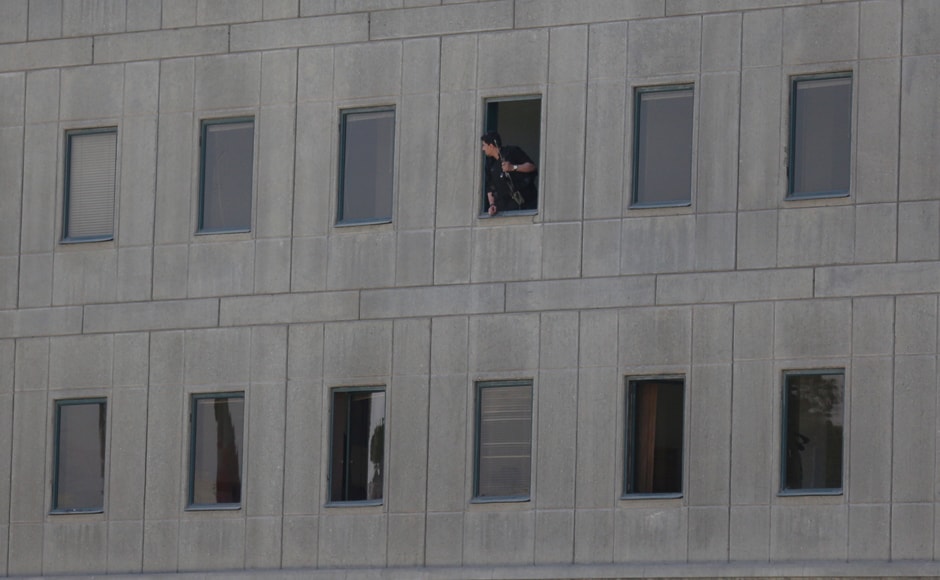 An Iranian policeman looks out of the Parliament building in central Tehran on Wednesday. Tima via Reuters An Iranian policeman looks out of the Parliament building in central Tehran on Wednesday. Tima via Reuters