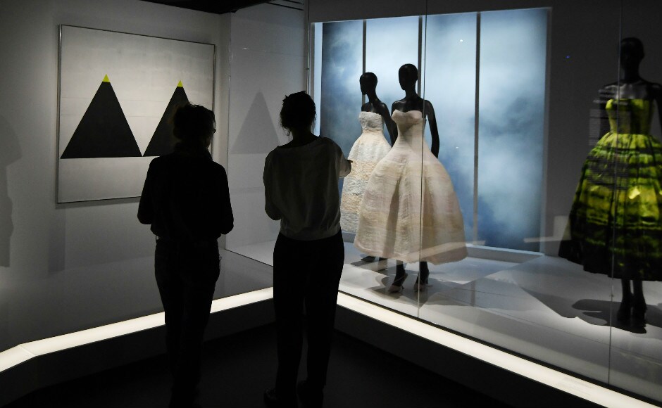 Visitors view dresses during the Dior exhibition. Photo: AFP Visitors view dresses during the Dior exhibition. Photo: AFP