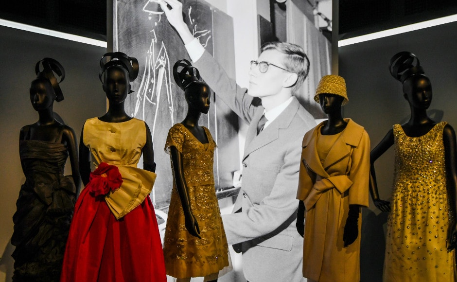 Dresses by French fashion designer Yves Saint Laurent (whose picture is seen behind) are photographed during the Dior exhibition that celebrates the seventieth anniversary of the Christian Dior fashion house on 3 July 2017 in Paris. Photo: AFP Dresses by French fashion designer Yves Saint Laurent (whose picture is seen behind) are photographed during the Dior exhibition that celebrates the seventieth anniversary of the Christian Dior fashion house on 3 July 2017 in Paris. Photo: AFP