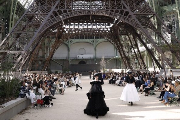Models present creations for Chanel under a replica of the Eiffel Tower at the Grand Palais in Paris. AFP PHOTO Models present creations for Chanel under a replica of the Eiffel Tower at the Grand Palais in Paris. AFP PHOTO