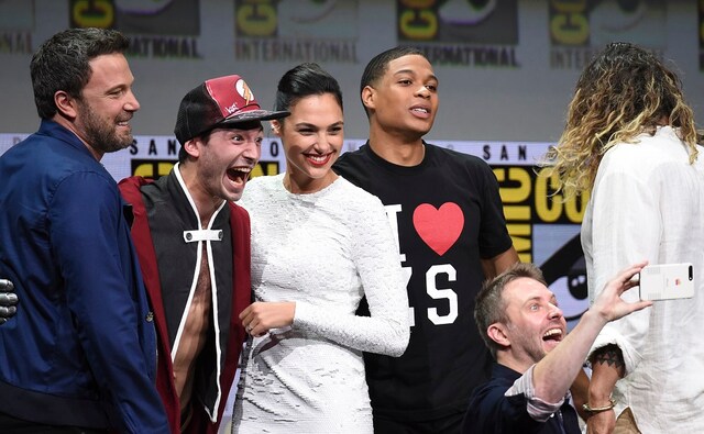 Moderator Chris Hardwick, foreground right, takes a selfie with from left, Ben Affleck, Ezra Miller, Gal Gadot, and Ray Fisher at the Warner Bros. Justice League panel on day three. Photo by AP Moderator Chris Hardwick, foreground right, takes a selfie with from left, Ben Affleck, Ezra Miller, Gal Gadot, and Ray Fisher at the Warner Bros. Justice League panel on day three. Photo by AP