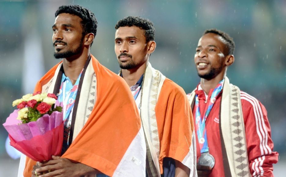 India's gold medalist Mohamed Anas Y (Centre) and silver medalist Arokia Rajiv of India (L) along with Ahmed Mubarak of Oman (R) during the medal ceremony of the 400m event. PTI India's gold medalist Mohamed Anas Y (Centre) and silver medalist Arokia Rajiv of India (L) along with Ahmed Mubarak of Oman (R) during the medal ceremony of the 400m event. PTI