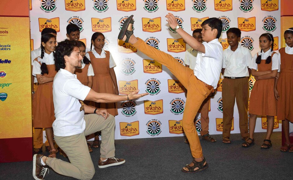 Tiger was spotted passing on some tips and ticks in martial arts to the children he met. Photo: Solaris Images Tiger was spotted passing on some tips and ticks in martial arts to the children he met. Photo: Solaris Images