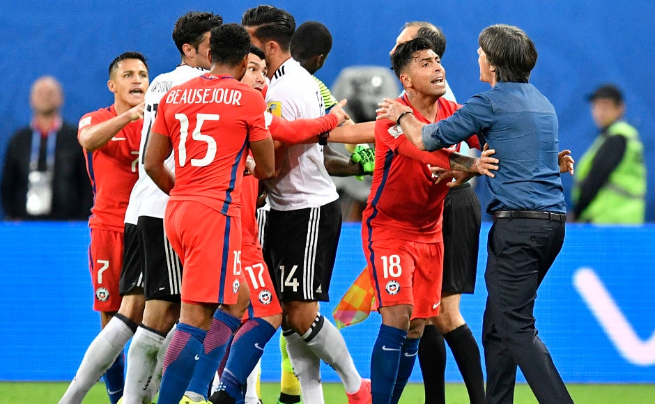 As the game progressed, the Chilean tempers started to fray. Germany coach Joachim Loew(R) tries to mediate an argument between Emre Can and Chile players. AP As the game progressed, the Chilean tempers started to fray. Germany coach Joachim Loew(R) tries to mediate an argument between Emre Can and Chile players. AP