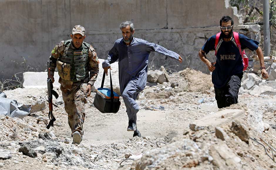An Iraqi soldier and civilians run to avoid Islamic State snipers in Shifa. Interior ministry forces recaptured the Ibn Sina hospital along with other medical facilities including a blood bank and a clinic, staff lieutenant general Abdulamir Yarallah said. The Islamic State occupied several Mosul hospitals during the battle for the city. Some security personnel have complained that restrictions on using heavy weapons against hospitals, intended to protect the facilities, have made operations riskier and more time-consuming. Reuters An Iraqi soldier and civilians run to avoid Islamic State snipers in Shifa. Interior ministry forces recaptured the Ibn Sina hospital along with other medical facilities including a blood bank and a clinic, staff lieutenant general Abdulamir Yarallah said. The Islamic State occupied several Mosul hospitals during the battle for the city. Some security personnel have complained that restrictions on using heavy weapons against hospitals, intended to protect the facilities, have made operations riskier and more time-consuming. Reuters