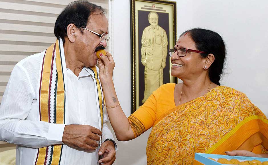 The government also hopes that Naidu's vast parliamentary experience will help in the smooth conduct of Rajya Sabha proceedings. <br />In this image, Naidu is offered sweets by his wife Usha at his residence. PTI The government also hopes that Naidu's vast parliamentary experience will help in the smooth conduct of Rajya Sabha proceedings. <br />In this image, Naidu is offered sweets by his wife Usha at his residence. PTI