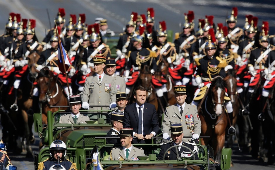 Macron vowed to "fight without mercy" inside and outside France to end extremist attacks. Some of the victims of the Nice attack and their families also attended the Bastille Day celebrations. AP Macron vowed to "fight without mercy" inside and outside France to end extremist attacks. Some of the victims of the Nice attack and their families also attended the Bastille Day celebrations. AP