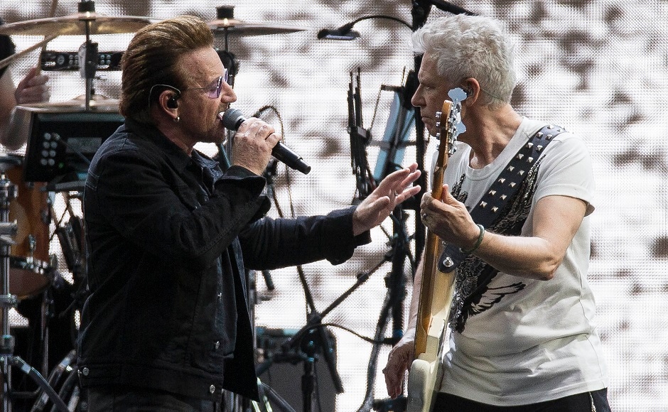 Singer Bono of the band U2, left, performs on stage with Adam Clayton. Photo by AP Singer Bono of the band U2, left, performs on stage with Adam Clayton. Photo by AP