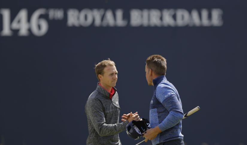 Jordan Spieth and Henrik Stenson shake hands after finishing their round on the first day of the British Open. AP