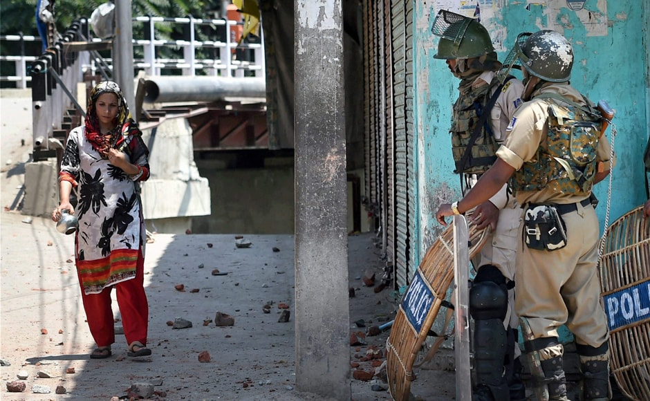 A woman walks on a road covered with stones after clashes between security forces and protesters in Srinagar on Saturday. Police fired tear gas canisters when protesters threw rocks at them. PTI A woman walks on a road covered with stones after clashes between security forces and protesters in Srinagar on Saturday. Police fired tear gas canisters when protesters threw rocks at them. PTI