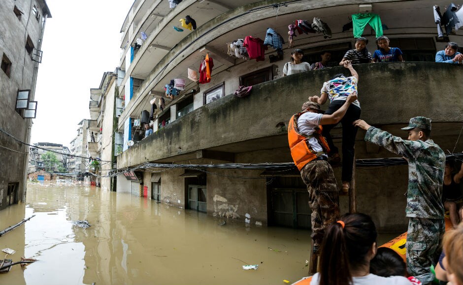 Rescuers transfer residents with a boat at a flooded area in Guilin, Guangxi province. Reuters Rescuers transfer residents with a boat at a flooded area in Guilin, Guangxi province. Reuters