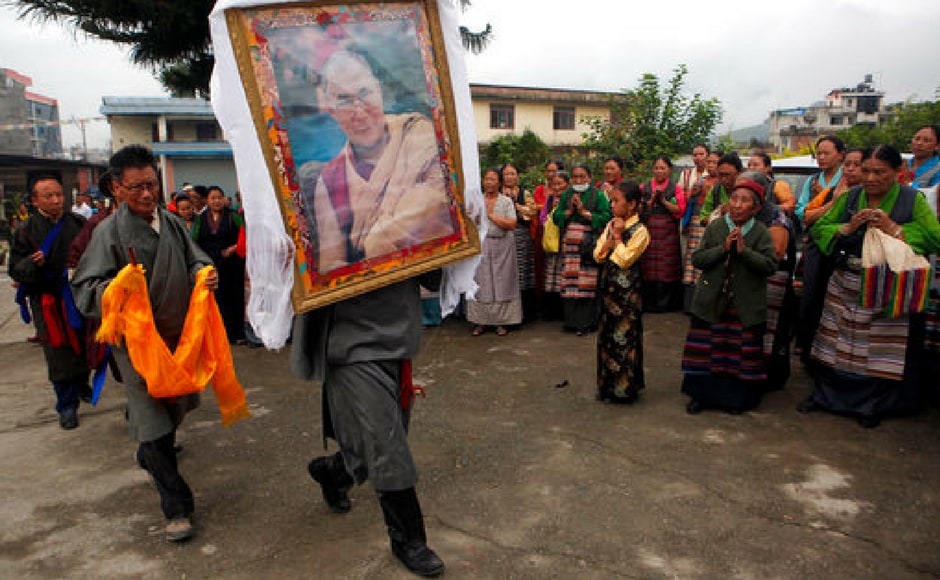 A Tibetan man carries a portrait of the Dalai Lama as members of the community gather to celebrate his 82nd birthday at a Tibetan camp in Lalitpur, Nepal. AP A Tibetan man carries a portrait of the Dalai Lama as members of the community gather to celebrate his 82nd birthday at a Tibetan camp in Lalitpur, Nepal. AP