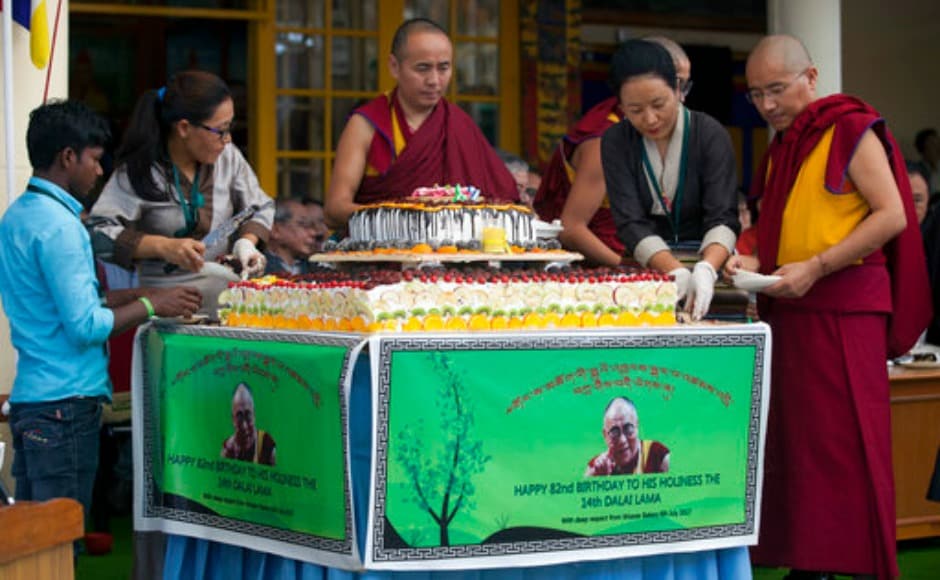 Exile Tibetan volunteers cut a large cake to be distributed among the crowd as they mark the 82nd birthday of the Dalai Lama in Dharamsala on Thursday. AP Exile Tibetan volunteers cut a large cake to be distributed among the crowd as they mark the 82nd birthday of the Dalai Lama in Dharamsala on Thursday. AP