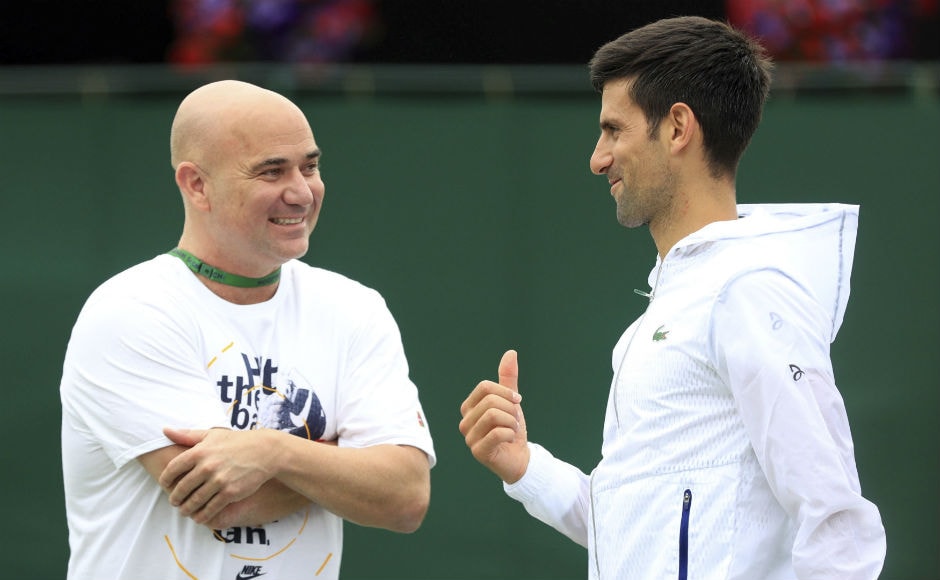 Novak Djokovic speaks with his coach former Wimbledon champion Andre Agassi on day two of the Wimbledon Tennis Championships in London.<br />AP Novak Djokovic speaks with his coach former Wimbledon champion Andre Agassi on day two of the Wimbledon Tennis Championships in London.<br />AP