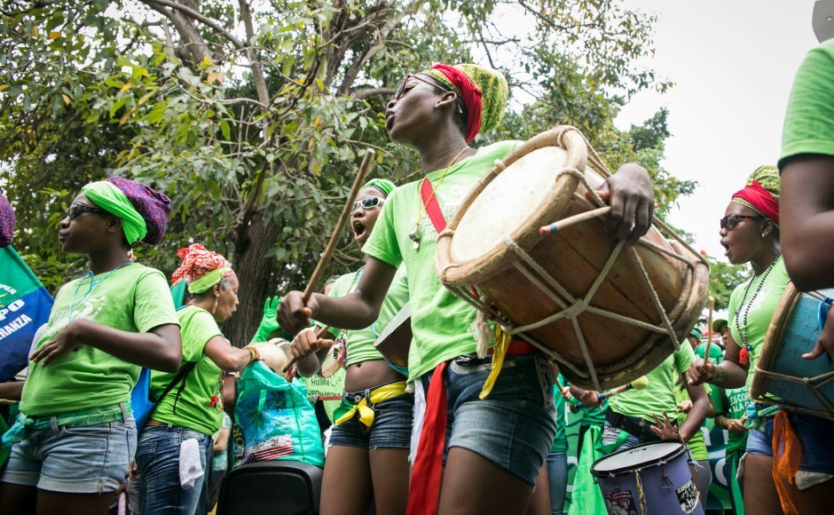 An Afro-Dominican dance troupe performs during the Green Movement's march, created to protest against corruption and demand an independent body for investigation on the scandal, in Santo Domingo. This protest is being termed as the mother of all marches. AP An Afro-Dominican dance troupe performs during the Green Movement's march, created to protest against corruption and demand an independent body for investigation on the scandal, in Santo Domingo. This protest is being termed as the mother of all marches. AP