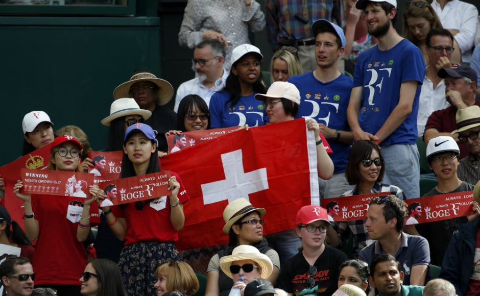 Fans of Roger Federer watch the Swiss ace's men's singles match against Ukraine's Alexandr Dolgopolov on day two at the Wimbledon Tennis Championships.<br />AP Fans of Roger Federer watch the Swiss ace's men's singles match against Ukraine's Alexandr Dolgopolov on day two at the Wimbledon Tennis Championships.<br />AP