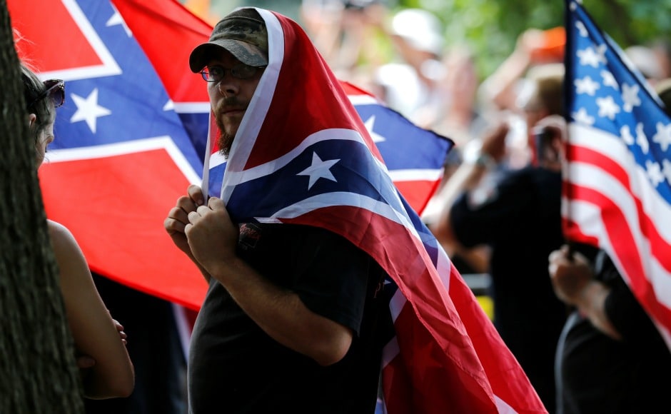 Dozens of marchers — some carrying Confederate flags, a handful in the distinctive white hood worn by Klan members — paraded past hundreds of people shouting "Racists go home!" and other chants. The two groups were separated by a metal barricade and a phalanx of armed police. Reuters Dozens of marchers — some carrying Confederate flags, a handful in the distinctive white hood worn by Klan members — paraded past hundreds of people shouting "Racists go home!" and other chants. The two groups were separated by a metal barricade and a phalanx of armed police. Reuters