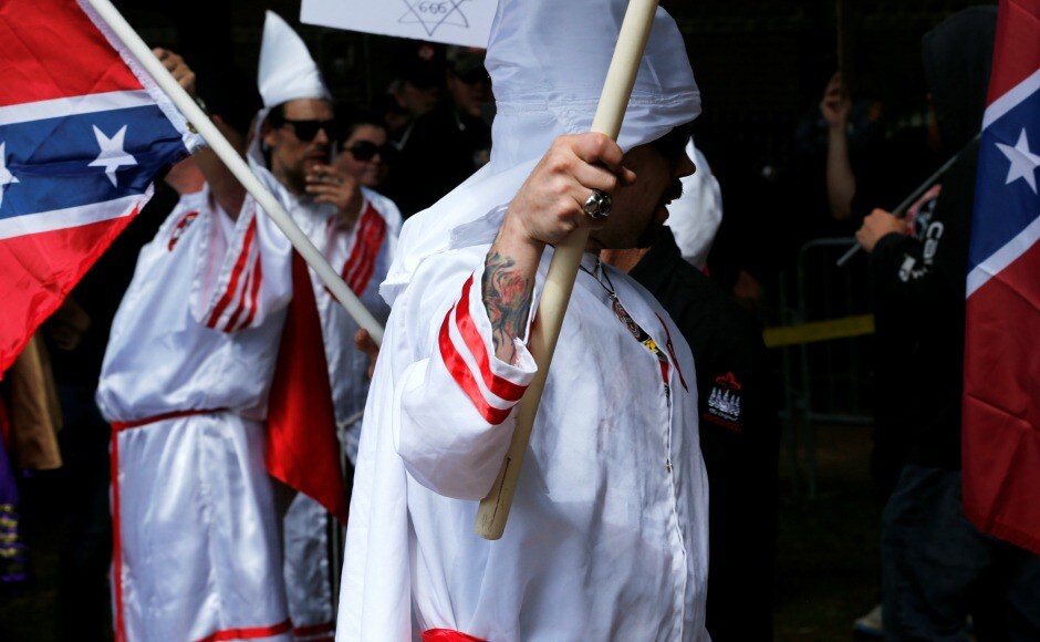 Anti-Klan protesters in Charlottesville got an early start overnight, throwing red paint on the bronze equestrian statue of the saber-wearing Confederate general. City workers were scrubbing the paint off early on Saturday. Reuters Anti-Klan protesters in Charlottesville got an early start overnight, throwing red paint on the bronze equestrian statue of the saber-wearing Confederate general. City workers were scrubbing the paint off early on Saturday. Reuters