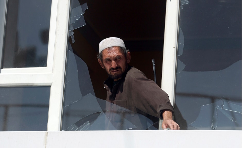 A man removes broken glasses from a window at the site of the suicide attack in Kabul. Most of the casualties were civilians, including women and children, but the dead also included Afghan security guards. AP A man removes broken glasses from a window at the site of the suicide attack in Kabul. Most of the casualties were civilians, including women and children, but the dead also included Afghan security guards. AP