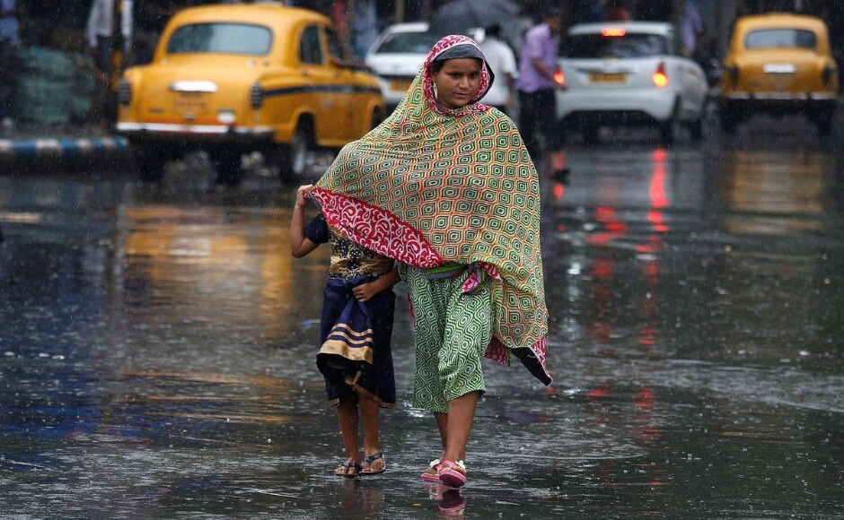 A mother protects her child from the rains on the streets of Kolkata, as thunderstorms and water logging were reported from various locations of the city later on Friday. Twitter@chmnaidu A mother protects her child from the rains on the streets of Kolkata, as thunderstorms and water logging were reported from various locations of the city later on Friday. Twitter@chmnaidu