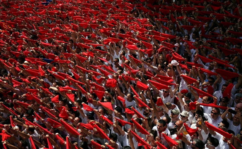 The crowds — most dressed in festival's typical white clothes and red neck scarf — kick start the festival with the slogan "Viva San Fermin!" or "Long Live San Fermin". Reuters The crowds — most dressed in festival's typical white clothes and red neck scarf — kick start the festival with the slogan "Viva San Fermin!" or "Long Live San Fermin". Reuters