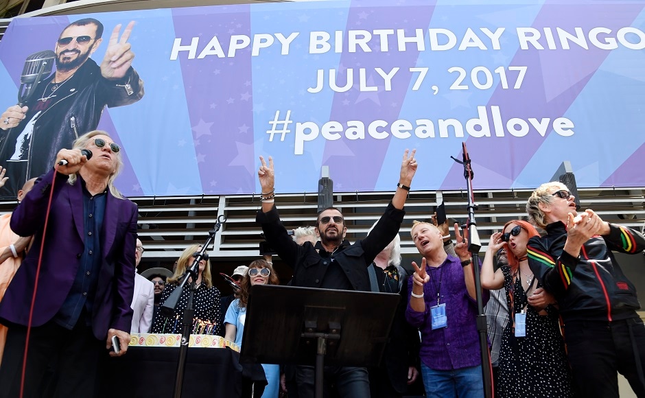 Starr, center, is joined by guitarist Joe Walsh, far left, and others onstage. Photo by AP Starr, center, is joined by guitarist Joe Walsh, far left, and others onstage. Photo by AP