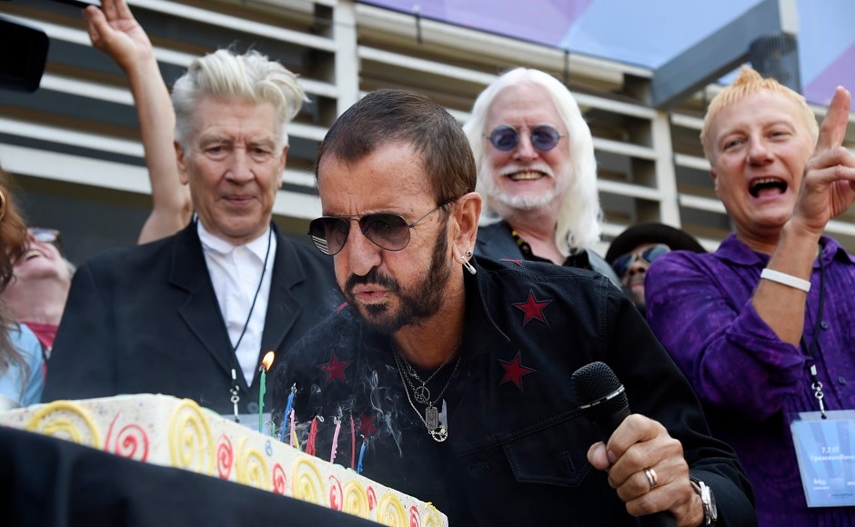 Ringo Starr blows out candles on his birthday cake in front of guests including filmmaker David Lynch, left, and musician Edgar Winter, second from right. Photo by AP Ringo Starr blows out candles on his birthday cake in front of guests including filmmaker David Lynch, left, and musician Edgar Winter, second from right. Photo by AP