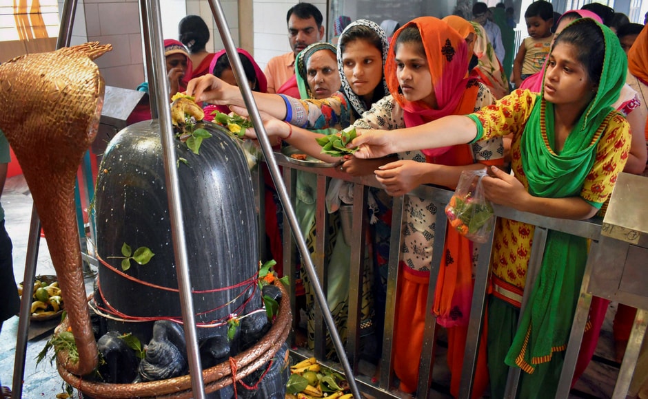 Women observe rituals of Sawan at Gurugram on Monday. PTI Women observe rituals of Sawan at Gurugram on Monday. PTI