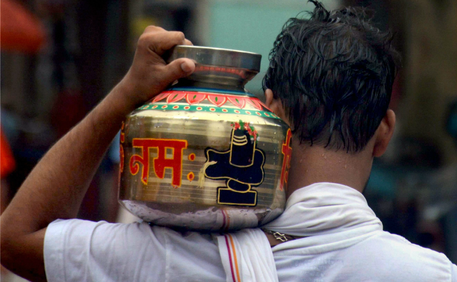 A devotee holds 'Gangajal' to perform 'Abhishek' of Lord Shiva at Kashi Vishwanath temple, on the occasion of Sawan Somvar in Varanasi. PTI A devotee holds 'Gangajal' to perform 'Abhishek' of Lord Shiva at Kashi Vishwanath temple, on the occasion of Sawan Somvar in Varanasi. PTI
