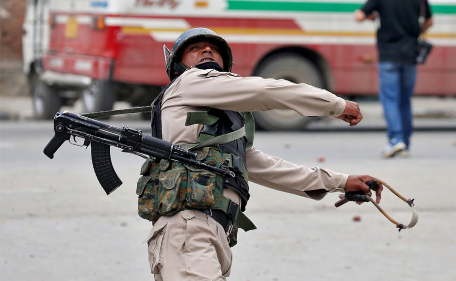 A police officer throws a rock at stone pelters during disturbances in Srinagar. Slender employment prospects prompt many residents of the region to join the police force. Reuters A police officer throws a rock at stone pelters during disturbances in Srinagar. Slender employment prospects prompt many residents of the region to join the police force. Reuters
