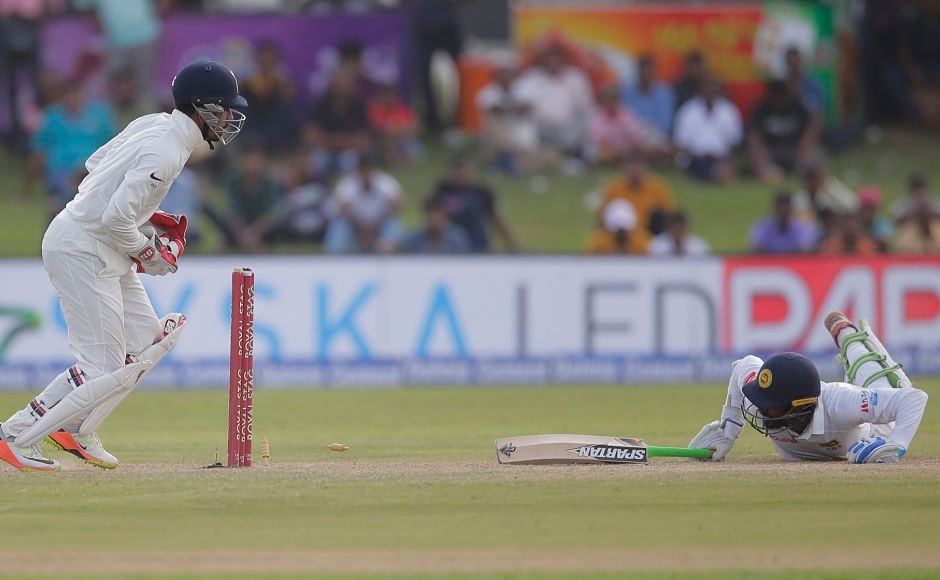 Abhinav Mukund, at short leg, and wicketkeeper Wriddhiman Saha combined to send Upul Tharanga back to the hut. AP