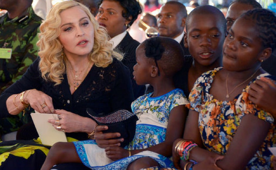 Madonna, left, sits with her adopted children Stella, David and Mercy, at the opening of The Mercy James Institute for Pediatric Surgery and Intensive Care, located at the Queen Elizabeth Central Hospital in the city of Blantyre, Malawi. (AP Photo) Madonna, left, sits with her adopted children Stella, David and Mercy, at the opening of The Mercy James Institute for Pediatric Surgery and Intensive Care, located at the Queen Elizabeth Central Hospital in the city of Blantyre, Malawi. (AP Photo)