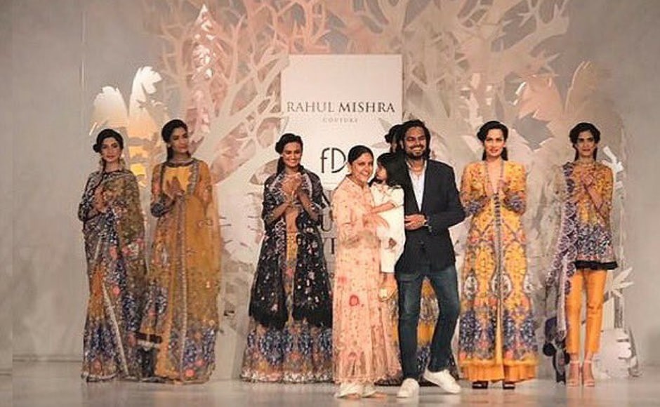 Rahul Mishra asked his family to wear his beautiful designs and walk the runway to close his instead of getting a celebrity to be the showstopper at his fashion show. Image via FDCI/twitter. Rahul Mishra asked his family to wear his beautiful designs and walk the runway to close his instead of getting a celebrity to be the showstopper at his fashion show. Image via FDCI/twitter.