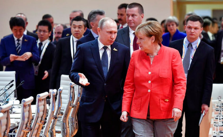Merkel talks with Russia's president Vladimir Putin at the start of the first working session of the G20 meeting. AP Merkel talks with Russia's president Vladimir Putin at the start of the first working session of the G20 meeting. AP