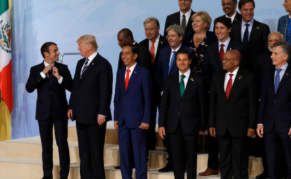 France's president Emmanuel Macron, left, adjusts his tie as he jokes with, from left, US president Donald Trump, Indonesian President Joko Widodo, Senegal's President Macky Sall and Mexican President Enrique Pena Nieto during the family photo. Reuters France's president Emmanuel Macron, left, adjusts his tie as he jokes with, from left, US president Donald Trump, Indonesian President Joko Widodo, Senegal's President Macky Sall and Mexican President Enrique Pena Nieto during the family photo. Reuters