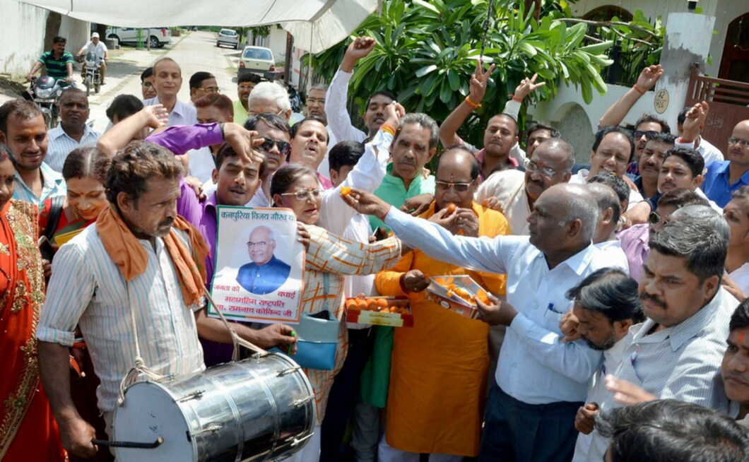 People celebrate outside Ram Nath Kovind's ancestral house in Kanpur on Thursday. PTI People celebrate outside Ram Nath Kovind's ancestral house in Kanpur on Thursday. PTI
