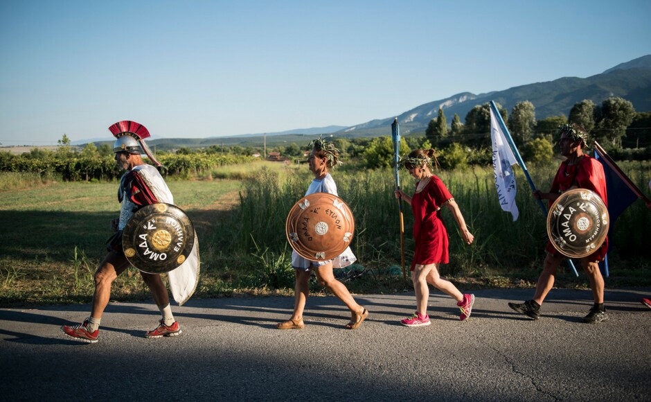 The annual run from the archaeological site of Dion sees runners dress as ancient warriors, wearing costumes once on sale as novelty items to tourists and now held together with staples and duct tape. AP The annual run from the archaeological site of Dion sees runners dress as ancient warriors, wearing costumes once on sale as novelty items to tourists and now held together with staples and duct tape. AP