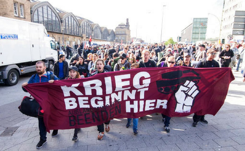 Activists carry a banner reading "The war starts here" as they march to their camp during the G20 summit. Reuters Activists carry a banner reading "The war starts here" as they march to their camp during the G20 summit. Reuters