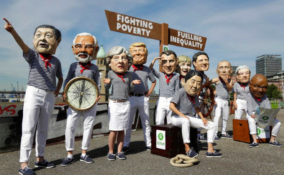 Activists from OXFAM wear masks depicting some of the world leaders during a demonstration during the G20 summit, Germany on Thursday. In the background is the "Elbphilharmonie" (Philharmonic Hall) where the G20 leaders will attend a concert. Reuters Activists from OXFAM wear masks depicting some of the world leaders during a demonstration during the G20 summit, Germany on Thursday. In the background is the "Elbphilharmonie" (Philharmonic Hall) where the G20 leaders will attend a concert. Reuters