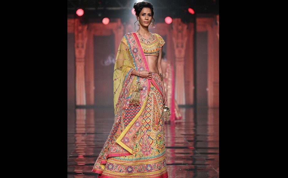 A mdoel walks the ramp wearing a lehenga which looks like a riot of colours. A mdoel walks the ramp wearing a lehenga which looks like a riot of colours.