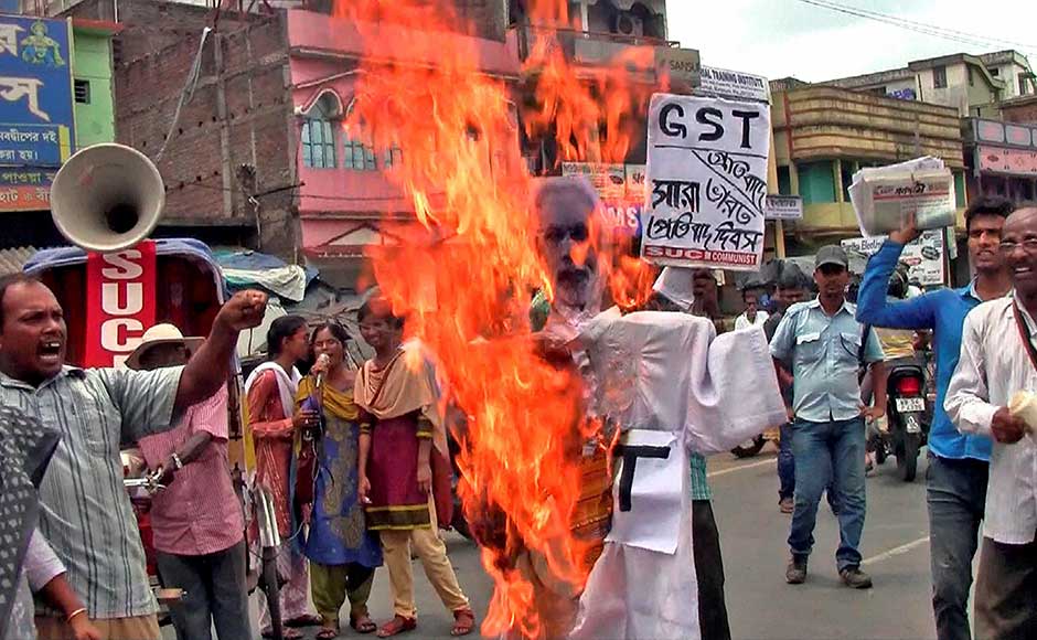 While there were celebrations across the nation, they were also interspersed with just as many protests. People burn an effigy during a protest against GST in Birbhum district of West Bengal. PTI While there were celebrations across the nation, they were also interspersed with just as many protests. People burn an effigy during a protest against GST in Birbhum district of West Bengal. PTI