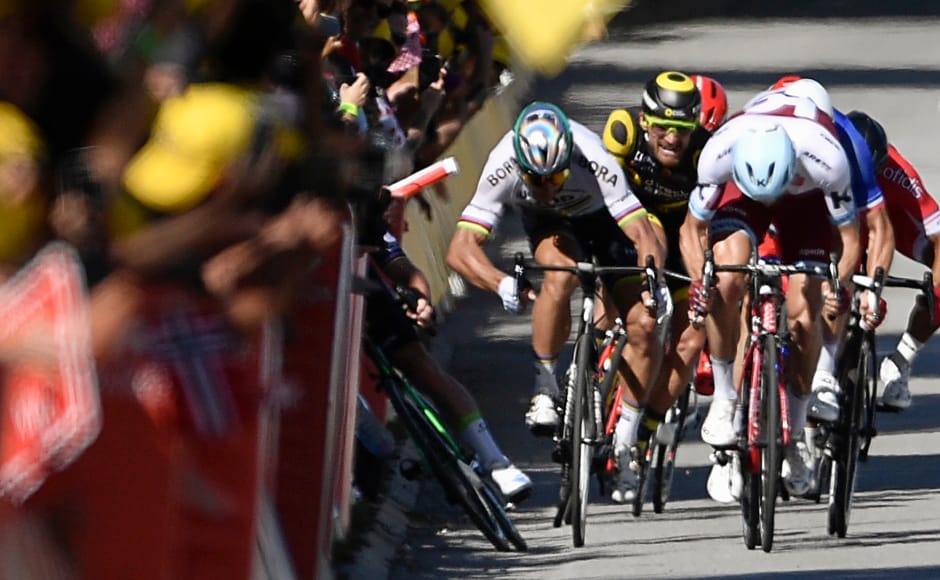 Slovakia's Peter Sagan elbows Great Britain's Mark Cavendish near the finish line at the end of the fourth stage of the Tour de France. AFP Slovakia's Peter Sagan elbows Great Britain's Mark Cavendish near the finish line at the end of the fourth stage of the Tour de France. AFP