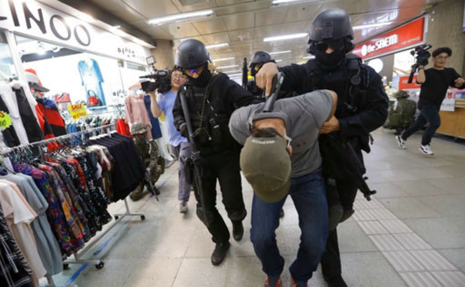 A mock terrorist is arrested by South Korean police officers during the anti-terror drill. The US and South Korea have begun the annual anti-terror drills involving almost 70,000 troops near the border that Seoul shares with North Korea. AP A mock terrorist is arrested by South Korean police officers during the anti-terror drill. The US and South Korea have begun the annual anti-terror drills involving almost 70,000 troops near the border that Seoul shares with North Korea. AP
