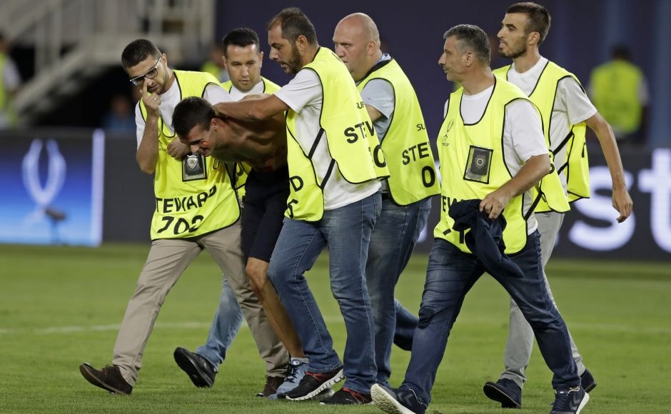 Moments before the final whistle, a shirtless fan ran onto the pitch and was wrestled to the ground by stewards. AP Moments before the final whistle, a shirtless fan ran onto the pitch and was wrestled to the ground by stewards. AP