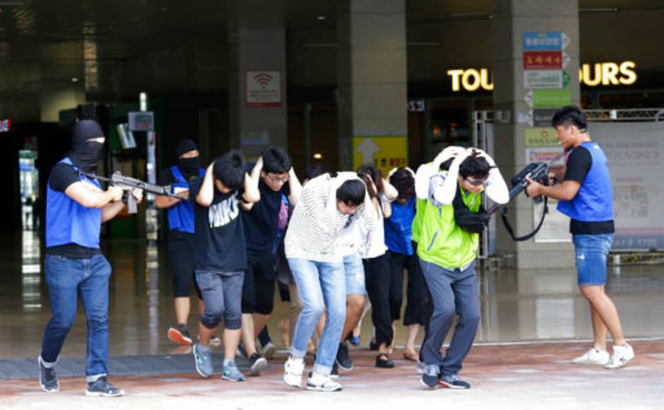As part of the exercise, mock terrorists threaten supposed hostages at a shopping centre in Goyang, South Korea. AP As part of the exercise, mock terrorists threaten supposed hostages at a shopping centre in Goyang, South Korea. AP